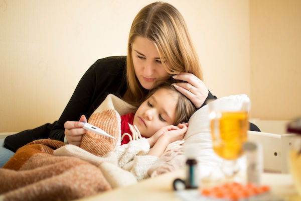 36257935 - young mother checking temperature of sick daughter lying in bed