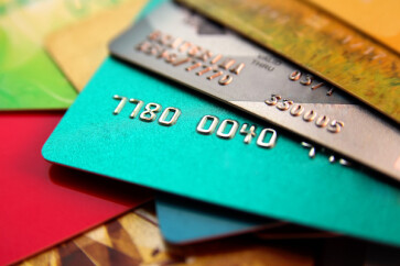 stack of multicolored credit cards, close up view with selective focus